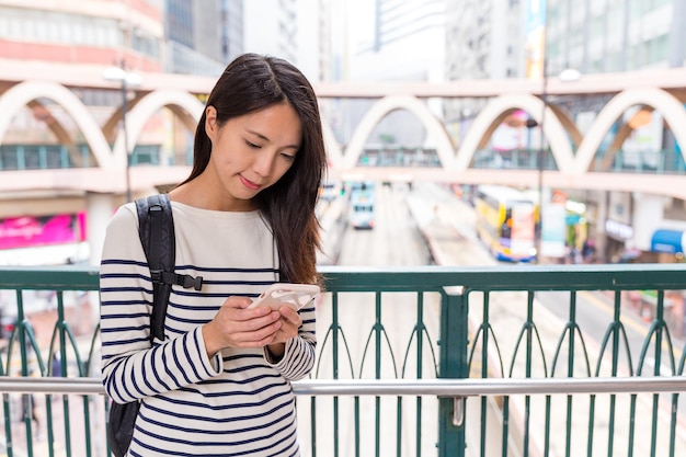 Mujer comprobando el teléfono inteligente en Hong Kong