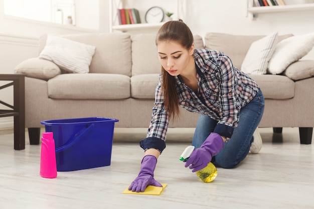 Mujer concentrada pulido piso de madera