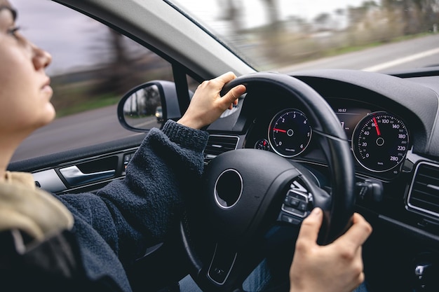 Mujer conductores manos en el volante de un coche