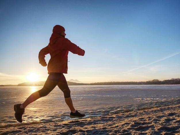Mujer corre en el beah deportes de invierno al aire libre fitness entrenamiento concepto de salud