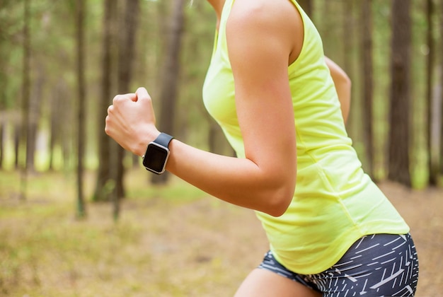 Mujer corriendo con reloj inteligente | Foto Premium