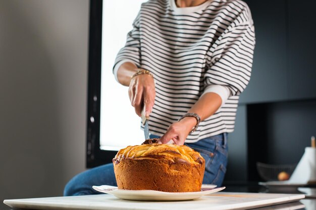 Mujer cortando tarta de manzana casera en la cocina