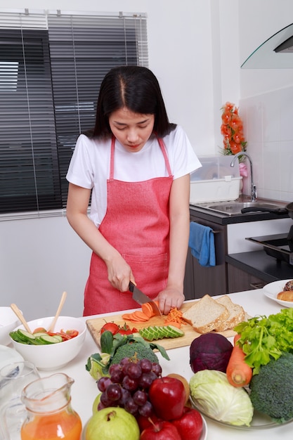 mujer cortando zanahoria en la cocina