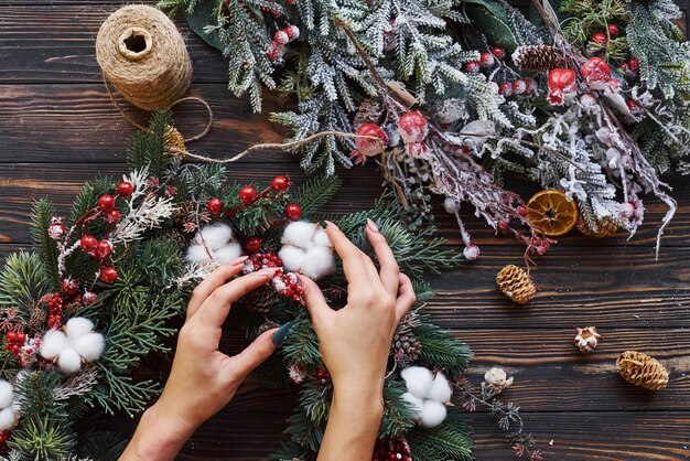 Mujer cuidando de adorno. Vista superior del marco festivo de navidad con adornos de año nuevo.