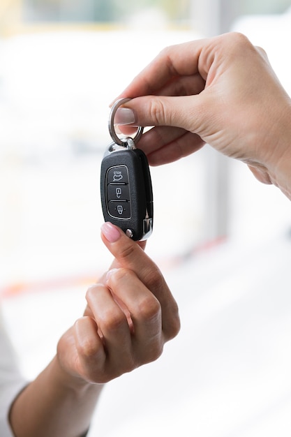 Mujer dando la llave del auto