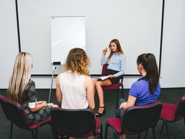 Mujer dirige cursos sobre mejora de la capacidad laboral. sesión de grupo. formación y comunicación profesional