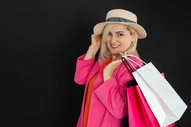 Mujer elegante con bolsas de compras negras, concepto de viernes negro