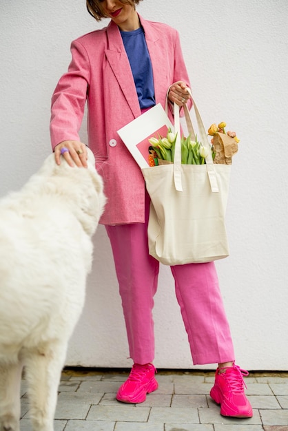 Mujer elegante con bolso de mano en el fondo