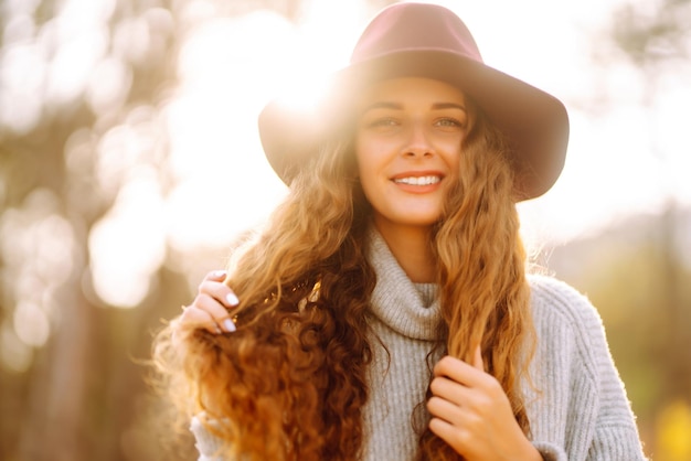 Mujer elegante en suéter y sombrero disfruta de la naturaleza otoñal Concepto de viaje de estilo de vida de libertad de personas