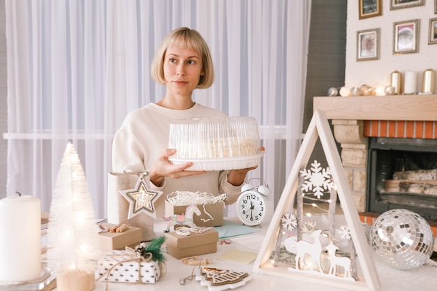 Mujer de embalaje de regalos de Navidad, regalo de embalaje para regalos de Navidad y Año Nuevo. Decoración de cajas de regalo navideñas. Preparándose para la Navidad. Vacaciones de invierno, concepto de decoración del hogar