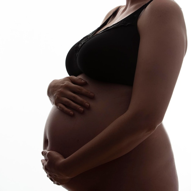 mujer embarazada, con, un, golpe de bebé, silueta, en, un, fondo blanco