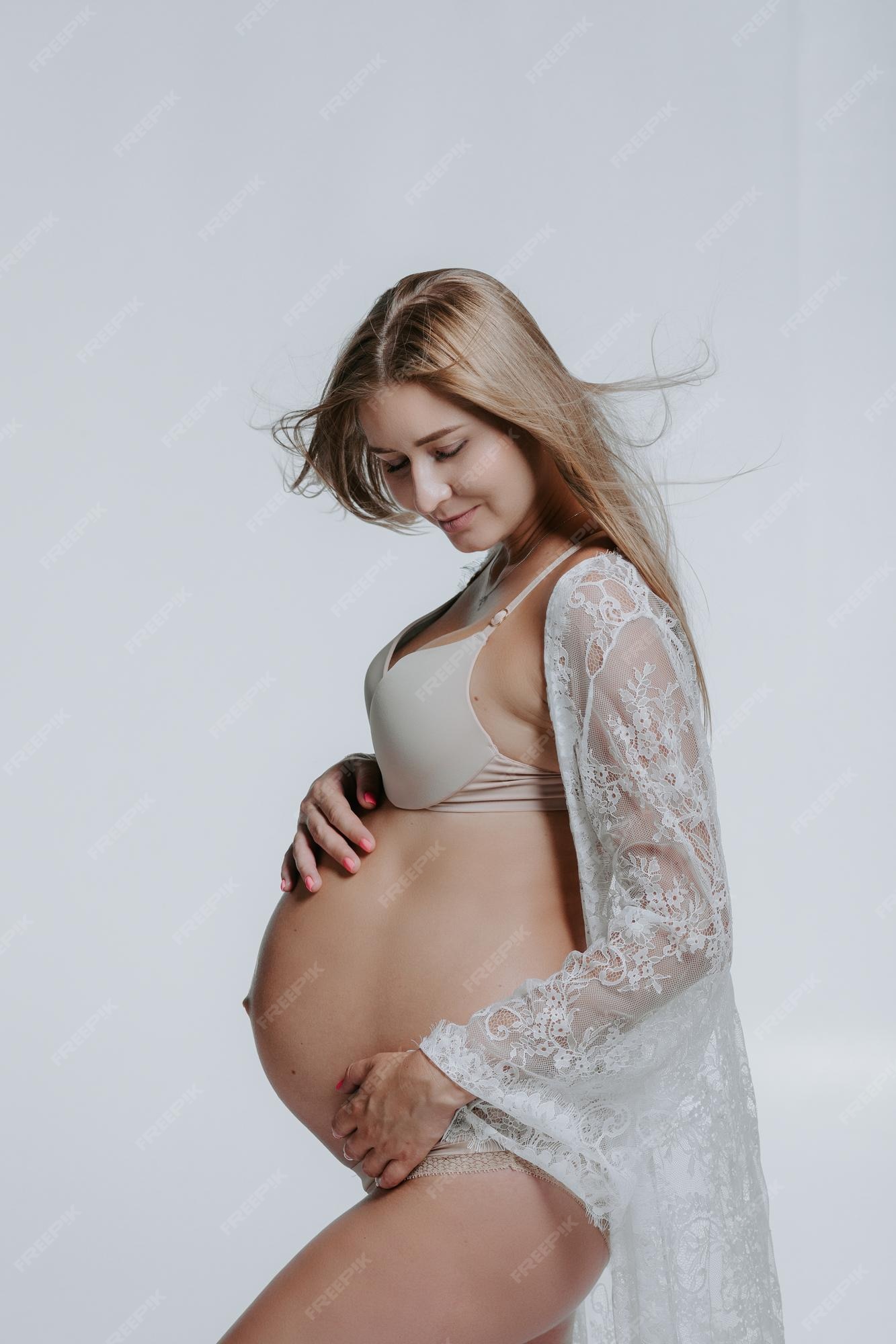 Mujer embarazada en ropa interior. de estudio | Foto
