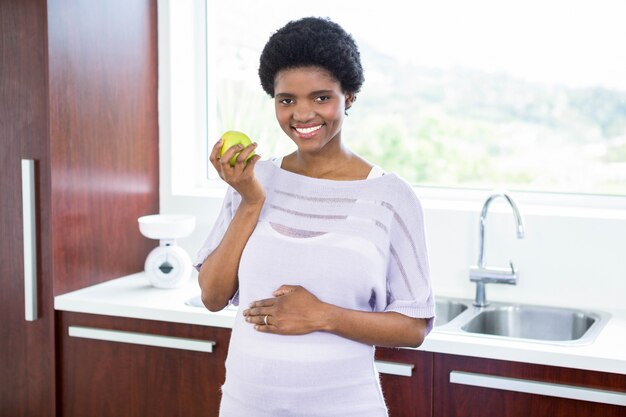 Mujer embarazada, tenencia, manzana, en, cocina