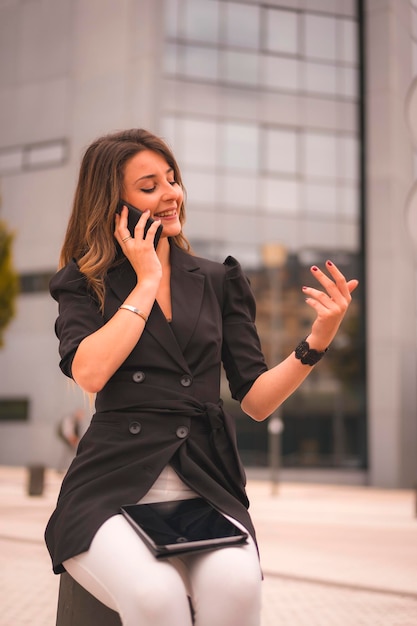 Mujer empresaria rubia fuera de la oficina hablando por teléfono una llamada de trabajo