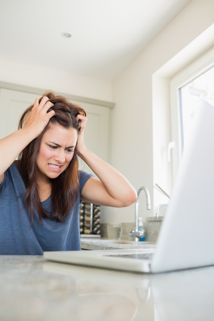 Foto mujer enojada con la computadora portátil