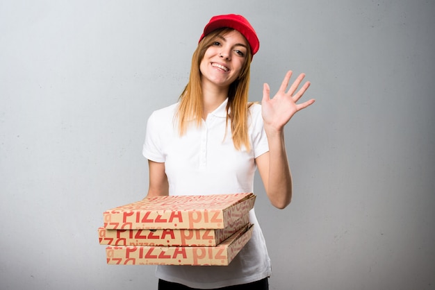 Mujer de entrega de pizza saludando sobre fondo con textura