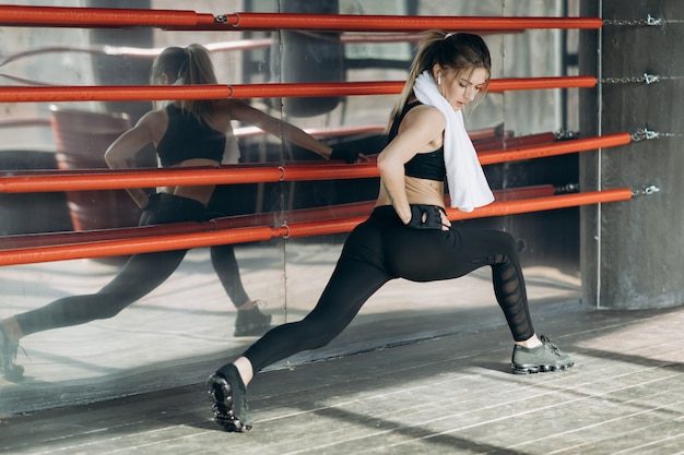 Mujer entrenamiento mañana entrenamiento en el gimnasio. Mujer joven haciendo ejercicios de gimnasio en el gimnasio