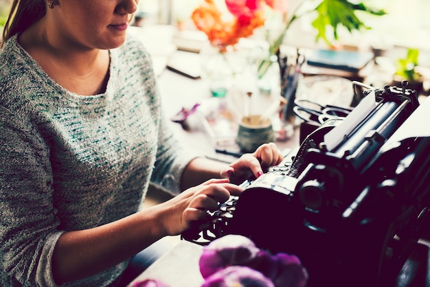 Mujer escribiendo en una máquina de escribir vintage