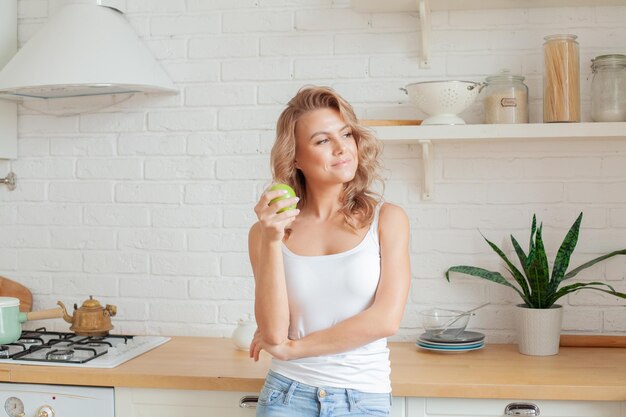 Foto mujer feliz de dieta con frutas de manzana en casa