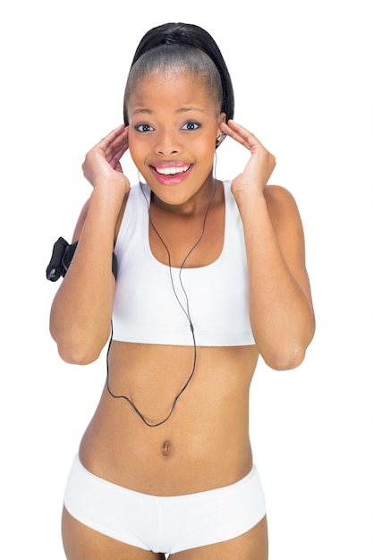 Mujer feliz en ropa deportiva escuchando música