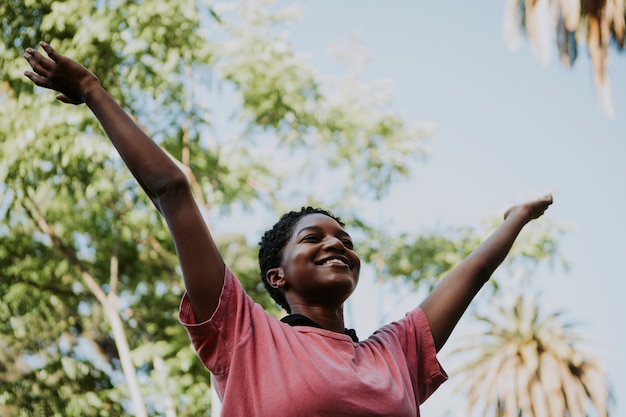 Mujer feliz sintiéndose libre en el parque