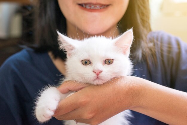 Mujer feliz sosteniendo gato escocés blanco esponjoso lindo animalito Lindo fondo de pantalla de gato