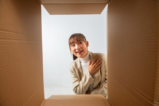 Foto mujer feliz con vista de caja abierta desde el interior