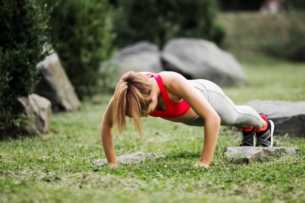 Mujer fitness haciendo ejercicio al aire libre en el parque.