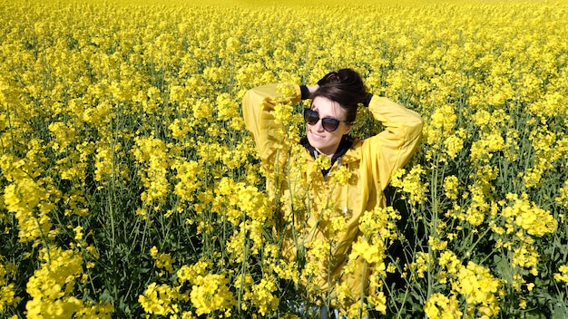 Mujer y flores amarillas de colza