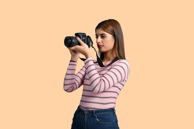 mujer fotógrafa haciendo clic en picutre con cámara modelo pakistaní indio