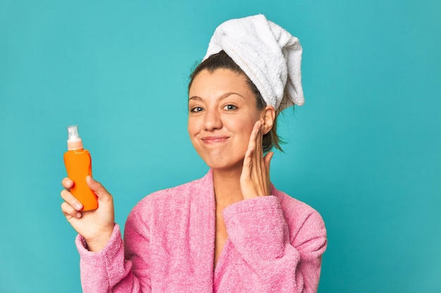 Mujer fresca y feliz con loción de protección solar