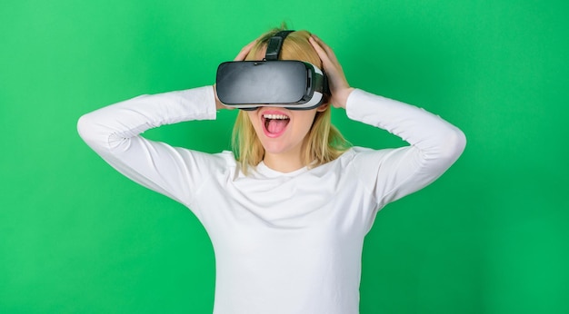 Mujer con gafas de realidad virtual en fondo verde Mujer con casco de realidad virtual