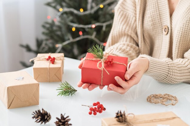 Mujer haciendo decoración navideña en la mesa