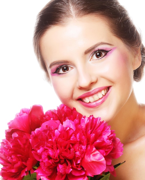 Mujer hermosa joven con peonía rosa