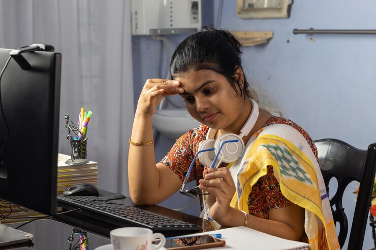 Foto mujer india en sari trabajando en la computadora desde casa y sintiendo dolor de cabeza trabajo desde el concepto de casa