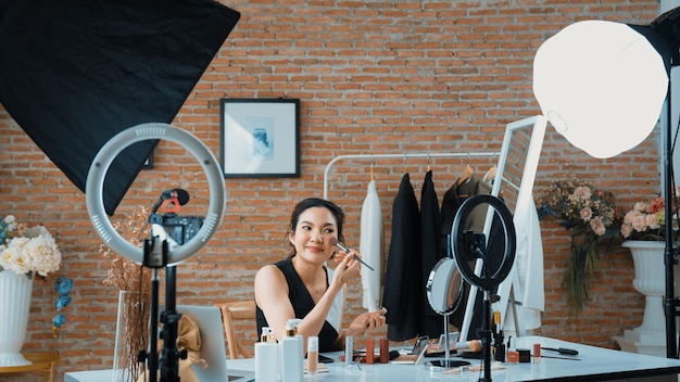 Mujer influyente dispara transmisión en vivo vlog video revisión vivacidad marketing de maquillaje