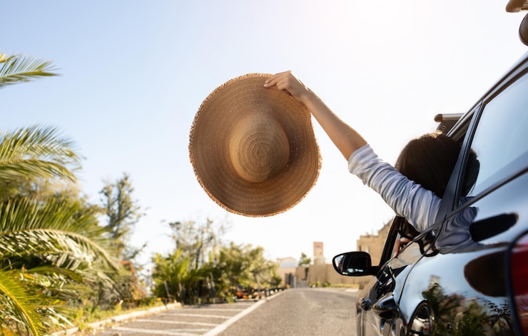 Foto una mujer irreconocible con un sombrero de mimbre del espacio de copia de la ventana del coche