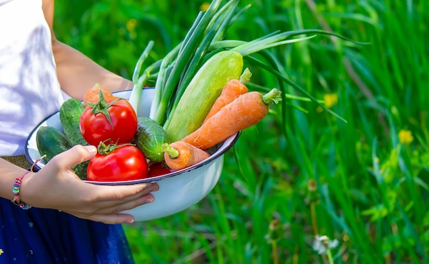 Mujer en el jardín con verduras en sus manos