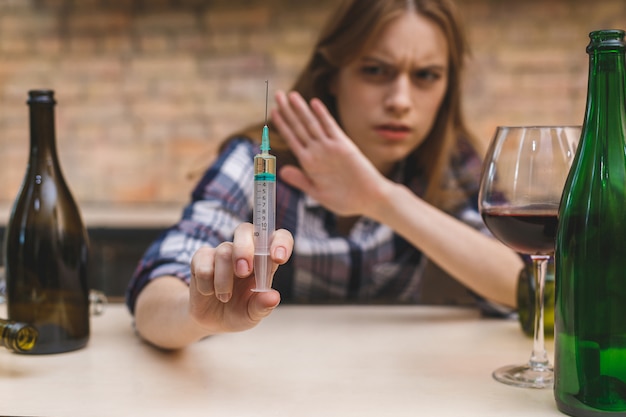 Foto mujer joven con adicción a las drogas y el alcohol.