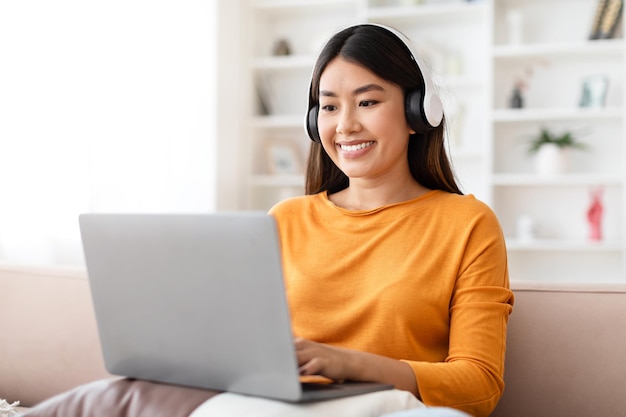 Mujer joven asiática feliz trabajando desde casa