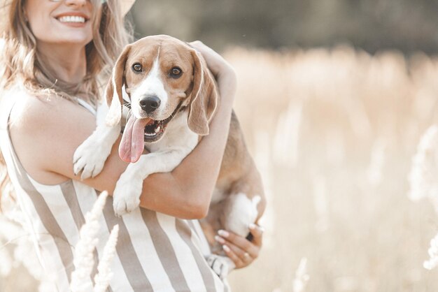 Mujer joven atractiva al aire libre con su mascota Dueño y perro juntos Amigos para siempre Dama y beagle