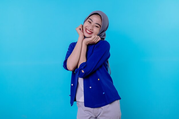 Mujer joven atractiva encantadora optimista con linda sonrisa alegre con bonita sonrisa blanca sobre fondo azul claro