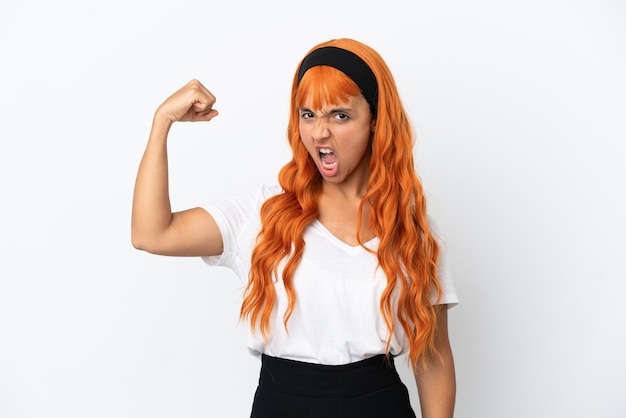 Mujer joven con cabello naranja aislado sobre fondo blanco haciendo gesto fuerte