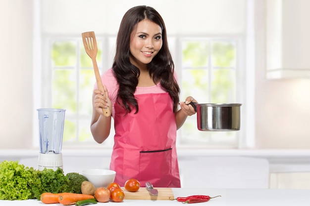 Mujer joven cocinando en la cocina