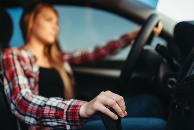 Mujer joven conduce un coche