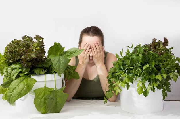 Foto mujer joven con un conjunto de ingredientes verdes lechuga espinaca para una dieta saludable