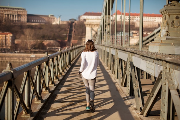 Mujer joven corriendo en la ciudad