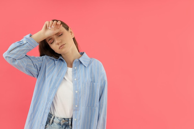 Foto mujer joven con dolor de cabeza sobre fondo rosa