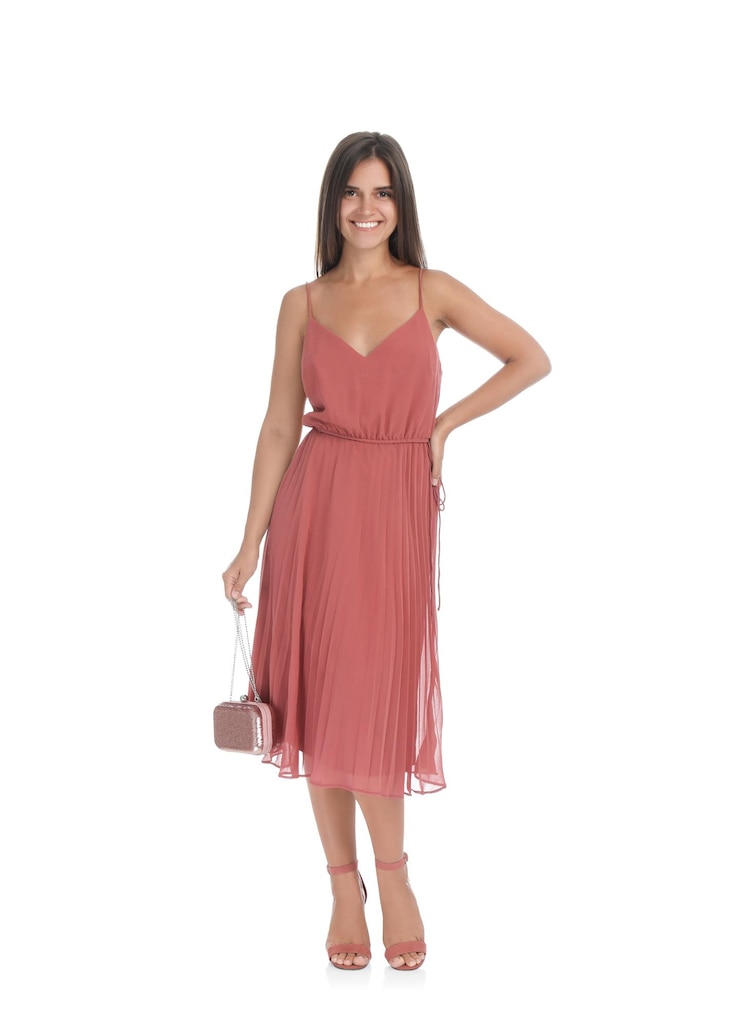 Foto mujer joven con elegante vestido rosa pálido sobre fondo blanco.