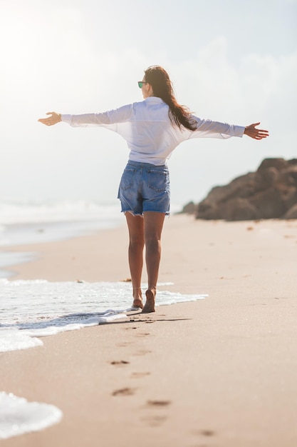 Mujer joven, feliz, en la playa